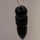 Pendule egyptien en onyx noir, sculpté en forme de pointe, suspendue par un anneau métallique.